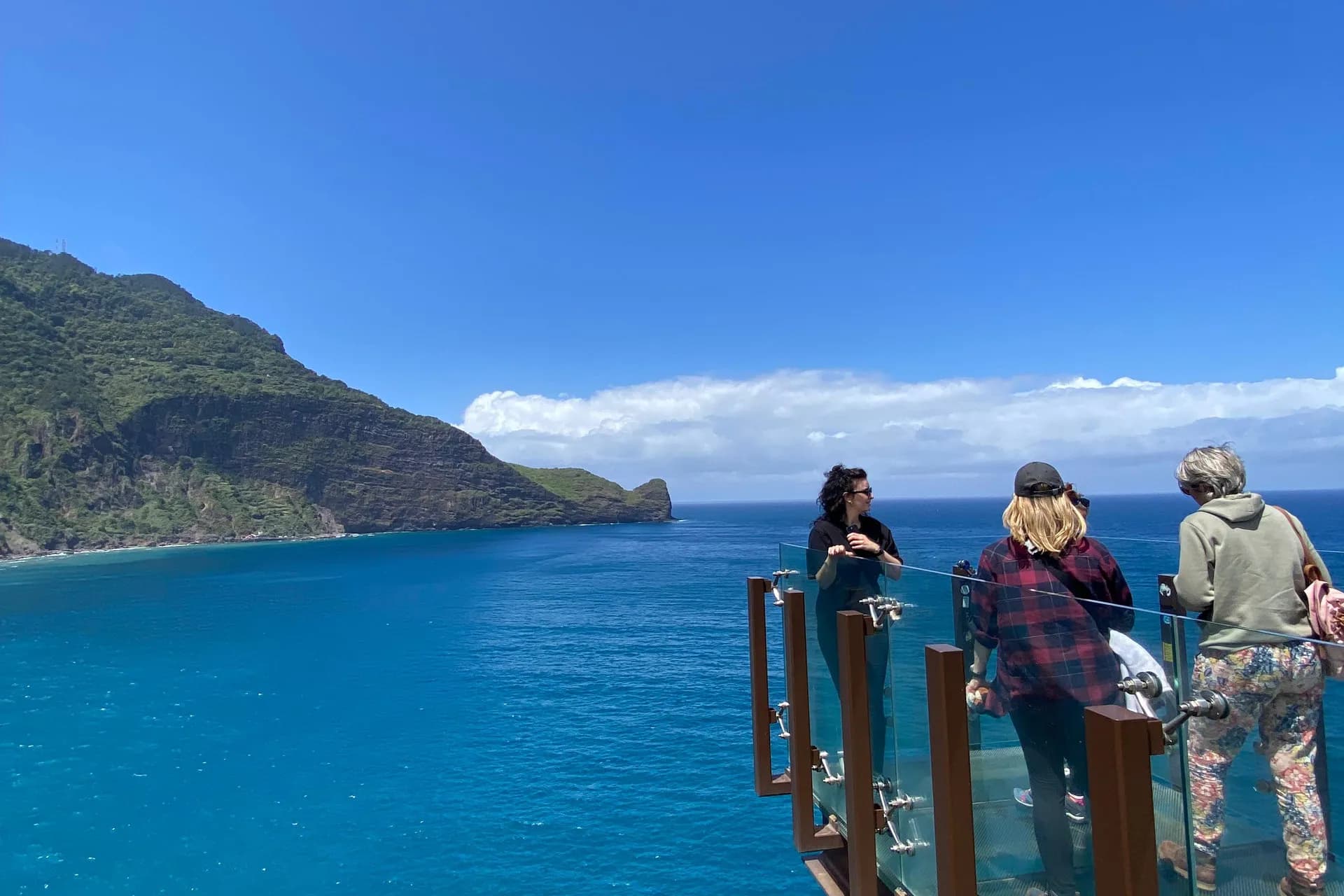 Guests enjoying the Guindaste glass viewpoint above Madeira’s north-east coast